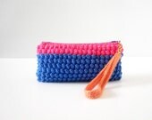 Crochet zipper clutch purse, wristlet  in cobalt blue and neon pink featuring wrist strap in peach cotton yarn.