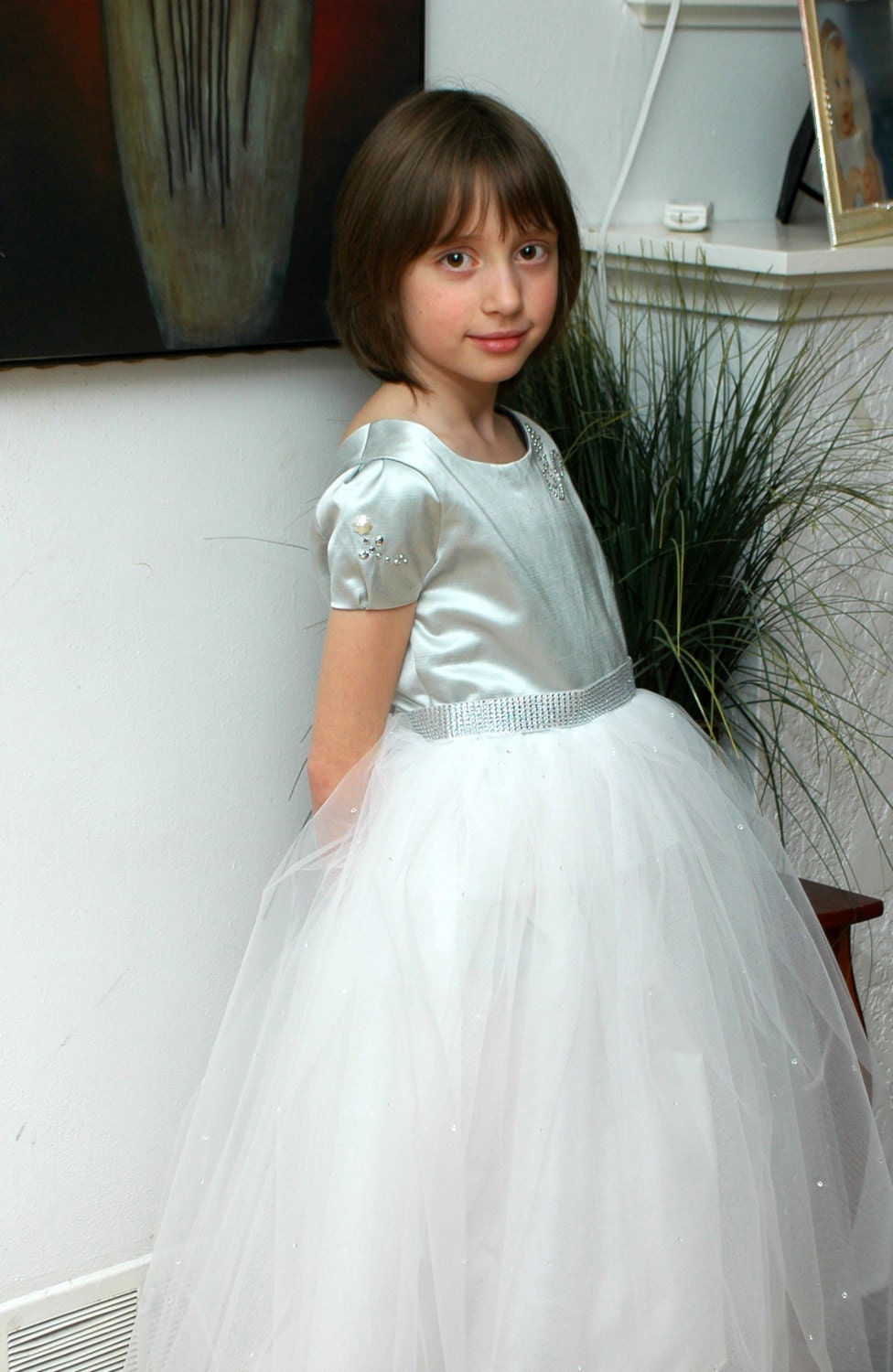 Flower girl dress with a silver top full skirt and a rhinestone design. Wedding dress for a flower girl