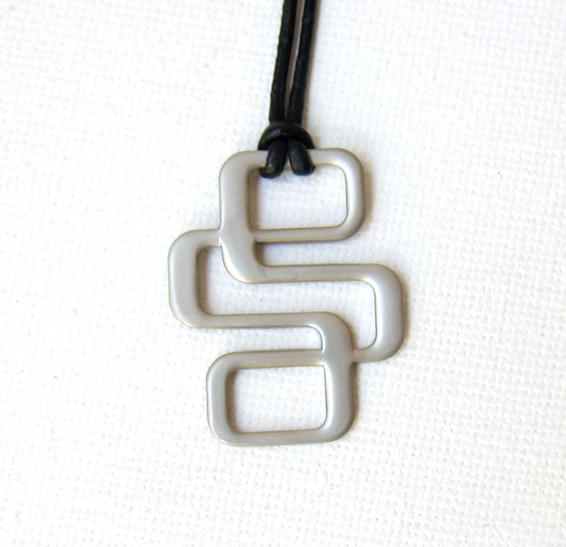 Vintage 1970s retro brushed silver metal atomic pendant