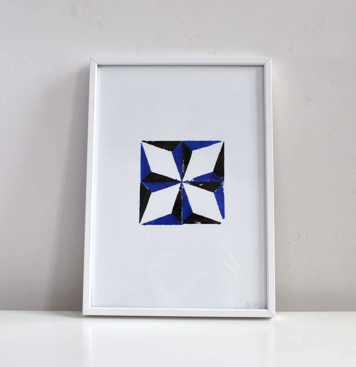 Islamic art relief print, star shape art in ultramarine blue, black and white.