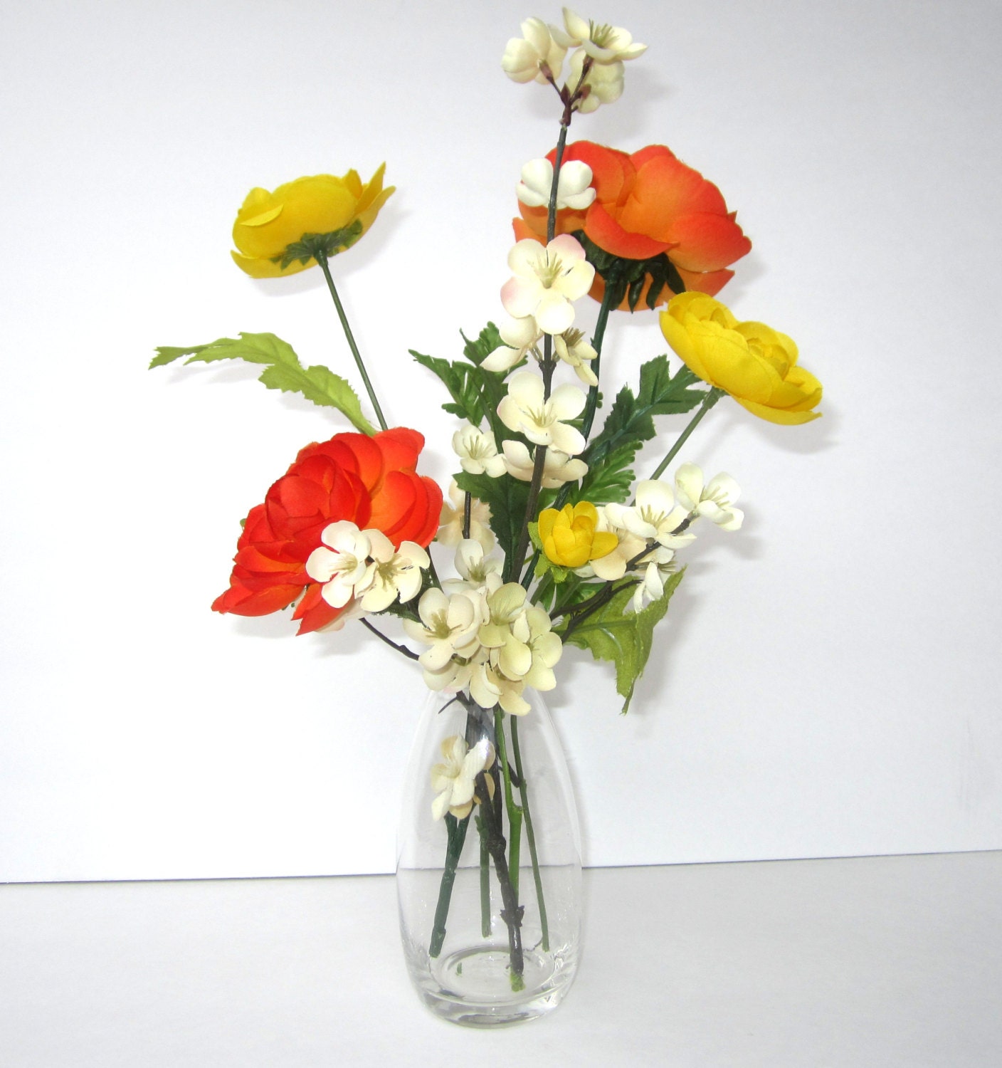 Silk Floral Arrangement In Acrylic Water With Yellow Orange & Cream Color Flowers