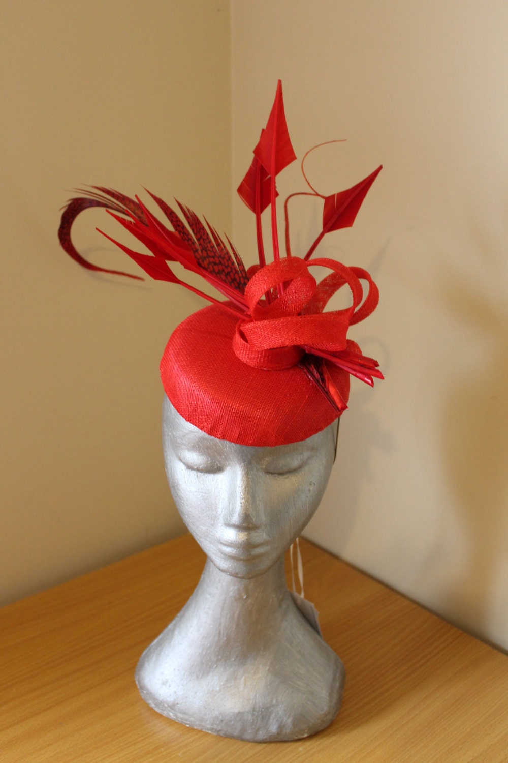 BESSIE statement red hat with arrow and feature feathers and quills