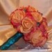 Shades of Coral Real Touch Roses Wedding Bouquet with Either Large or Smaller Teal Crystal Accents and Satin Hand Tied Stems.