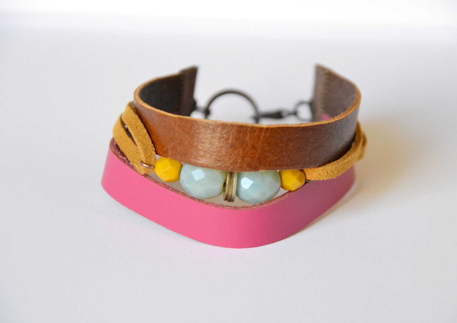 Leather and suede cuff. Hand cut tan and fushia leather with tan suede and stones. Small size.