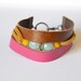 Leather and suede cuff. Hand cut tan and fushia leather with tan suede and stones. Small size.