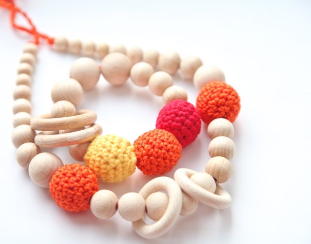 Set of 2. Bright orange nursing rings necklace and sunny teething ring toy.
