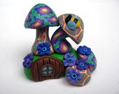Miniature fairy mushroom house, bright spring colors, tiny door with window, purple flowers in the garden and a tiny bee
