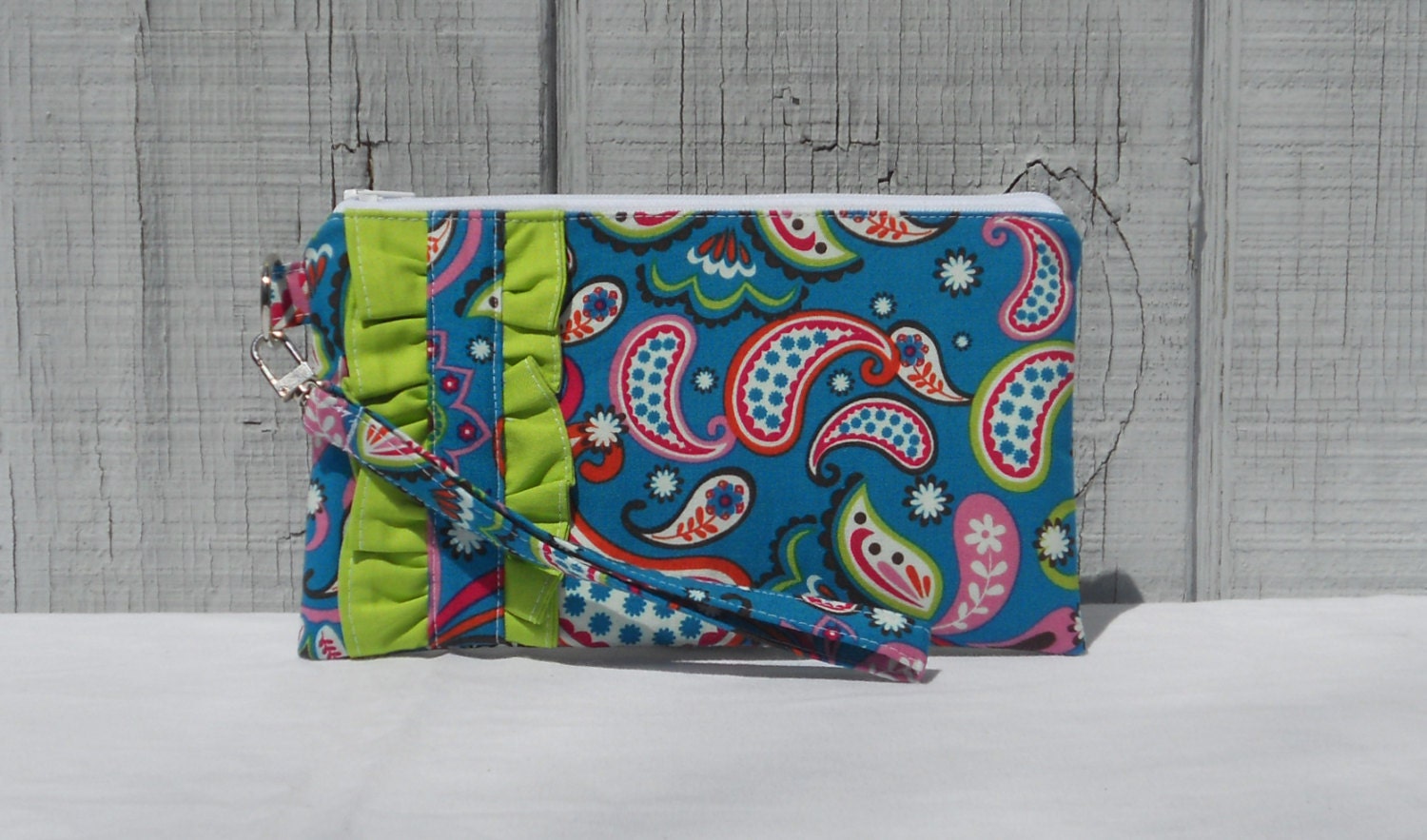 Clutch wristlet with ruffle accent, blue paisley