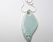 Large leaf shaped porcelain pendant, pale green crackle celadon glaze, with white and gold flowers