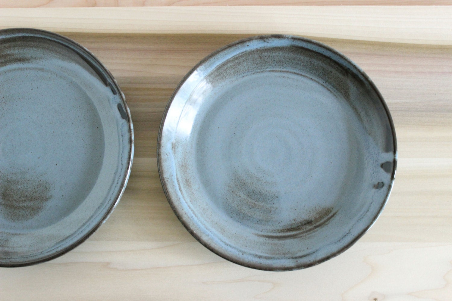 Flow pattern plate set, two 8 in. plates, blue-brown on chocolate brown