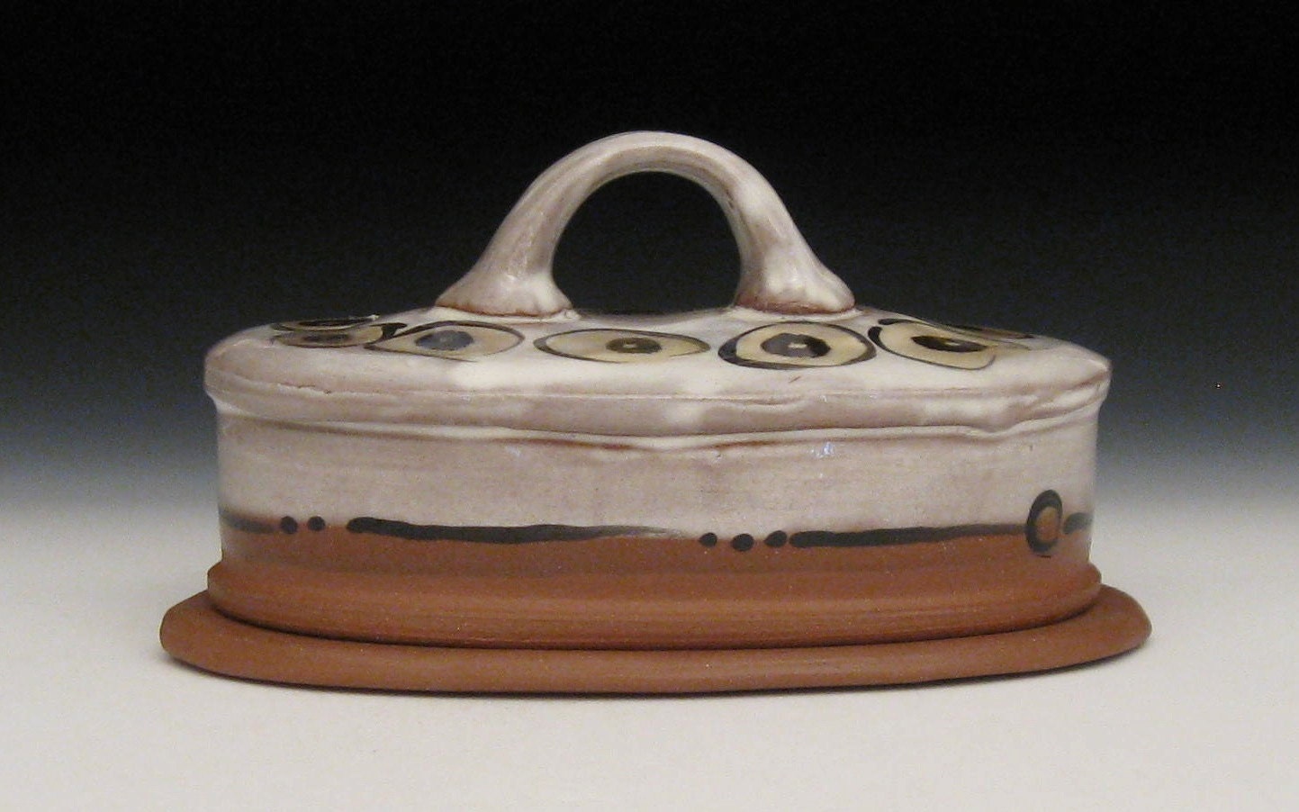 white amber black and brown butter dish with handle
