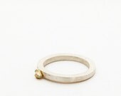 Silver ring with a drop of gold