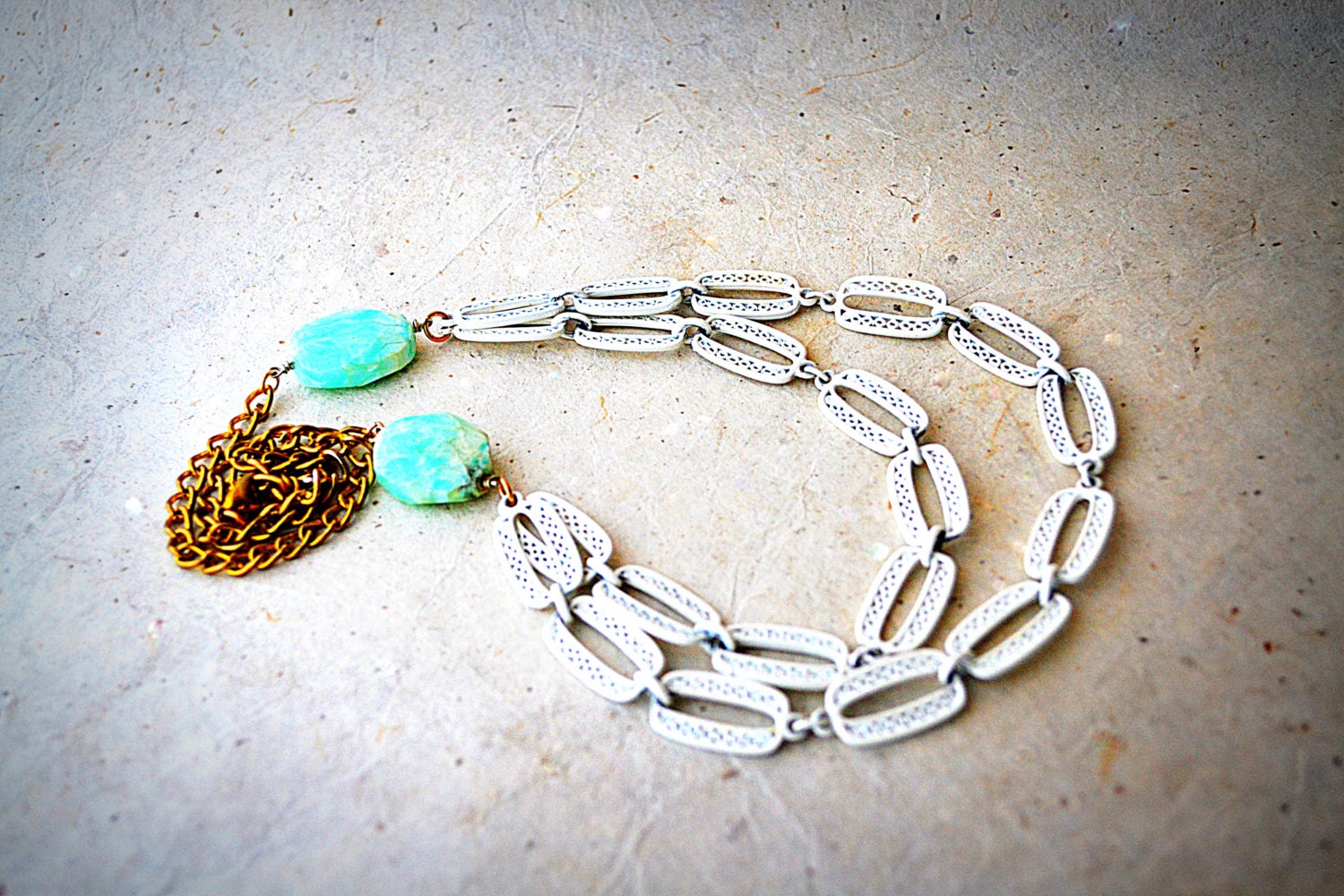 Recycled Materials Bib Necklace In Brass, White Lace Chain, and Aqua Blue Beads.