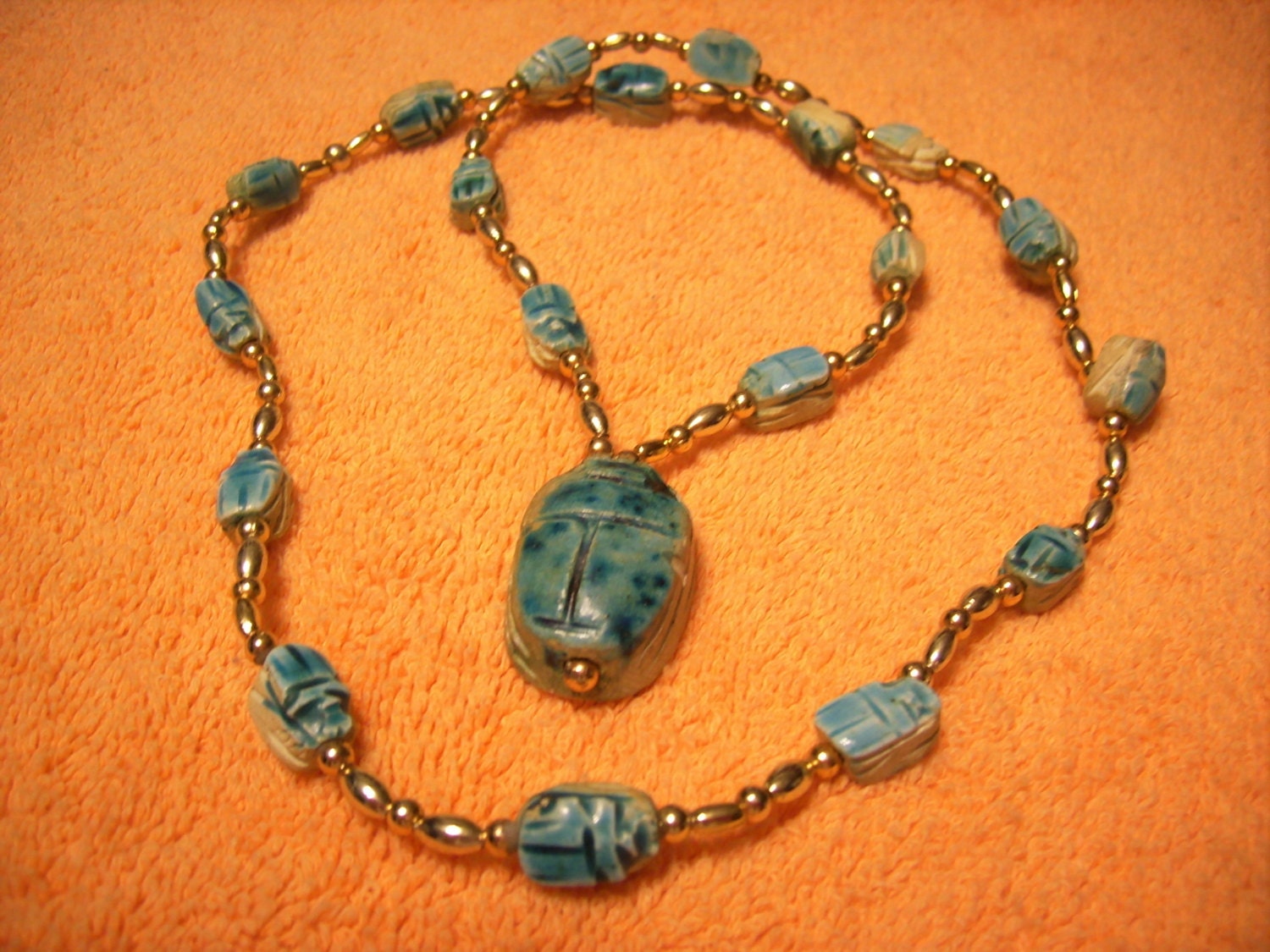 Egyptian Revival art deco scarab necklace. multiple scarabs with gold colored beads