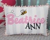 Baby pillow in light gray stripes with bumble bee accent. Personalized with name.