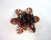 Medium Size Decorative Metal Hand Cut and Hand Painted Rustic Chocolate Burnt Brown Rose Mounted on a Bed of Metal Leaves.