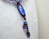 Purple wire wrapped blue glass bead. Beaded ribbon necklace. Frosty blue ribbon. Purple and blue bead jewelry.