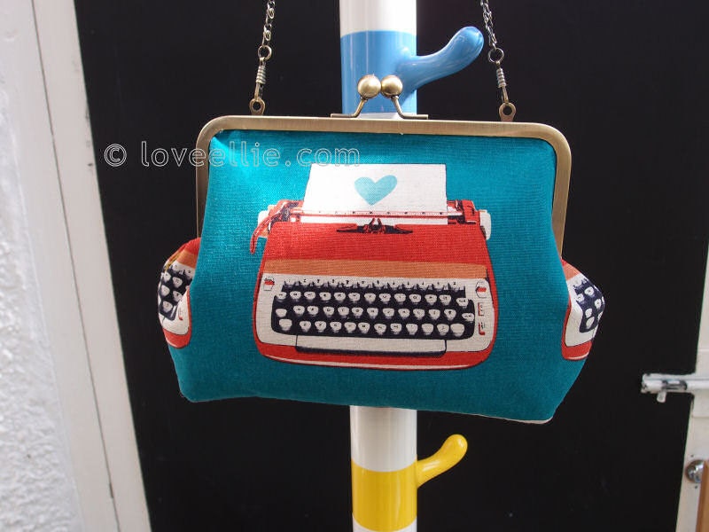 Handmade Clutch Style Purse in Teal Typewriter Cotton Fabric with Kiss Clasp Closure and optional Hand Chain