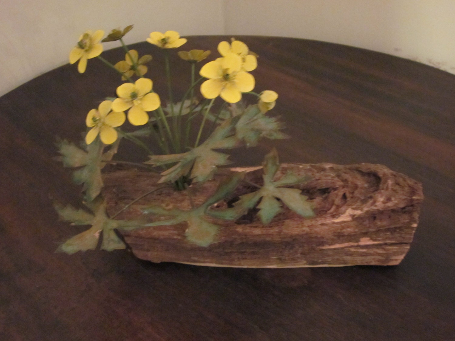 Table Ornament of Yellow Flowers Growing out of a Log. Flowers and Leaves Made of Copper.