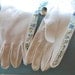 White cotton gloves with blue floral embroidery