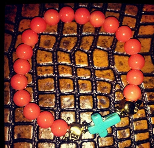 Elastic Coral bead bracelet with stone cross and gold plated skulls
