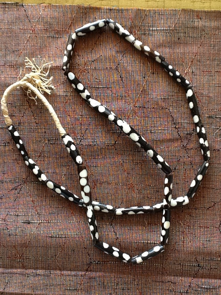 African Black and white batik bone pipe beads on raffia