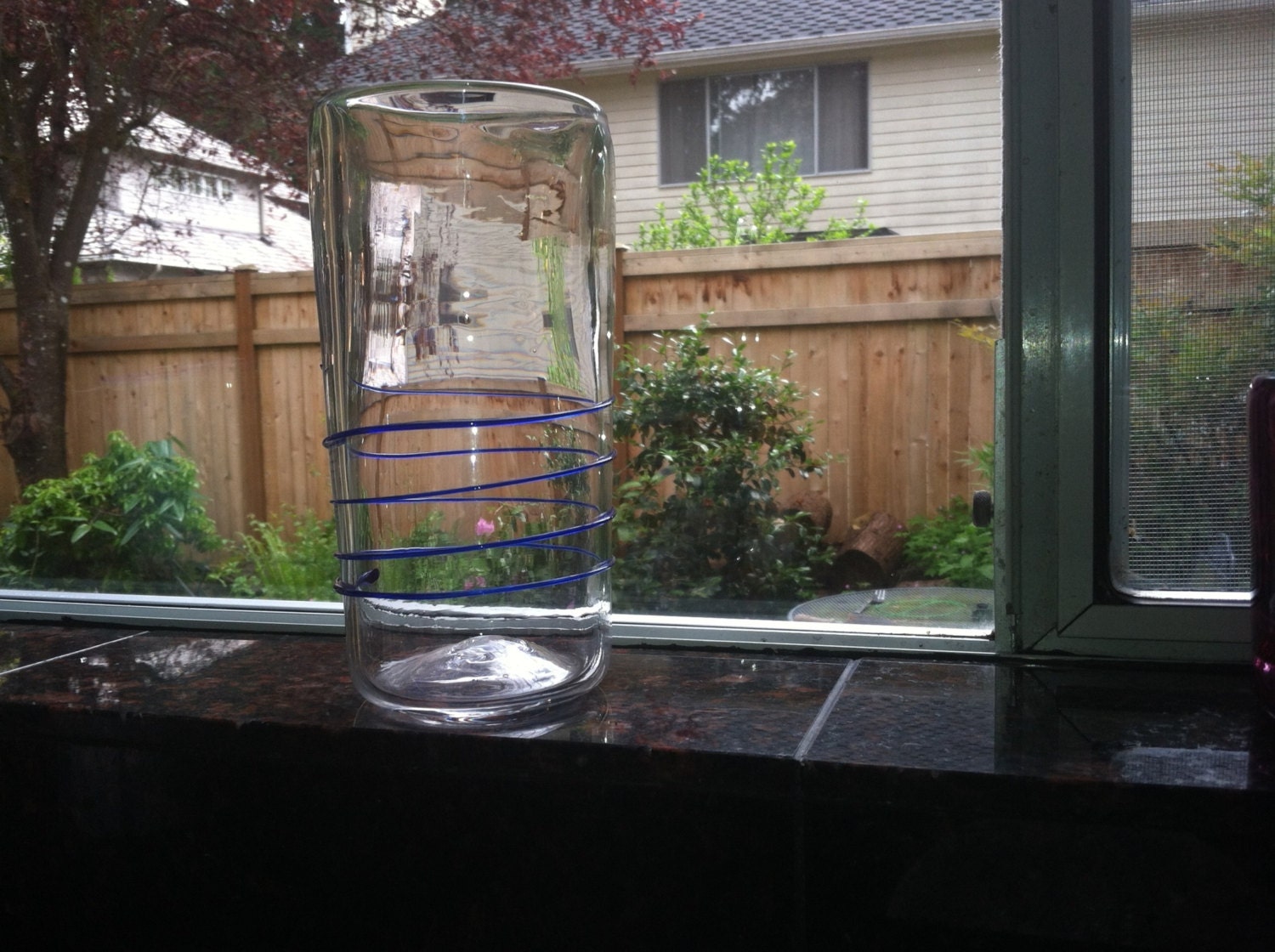 Hand blown vase with bright blue spiral