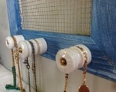 Upcycled blue wood frame jewelry holder with antique insulator knobs - white and copper accents