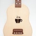 Ukulele (customizable sound hole of choice) Example: coffee cup