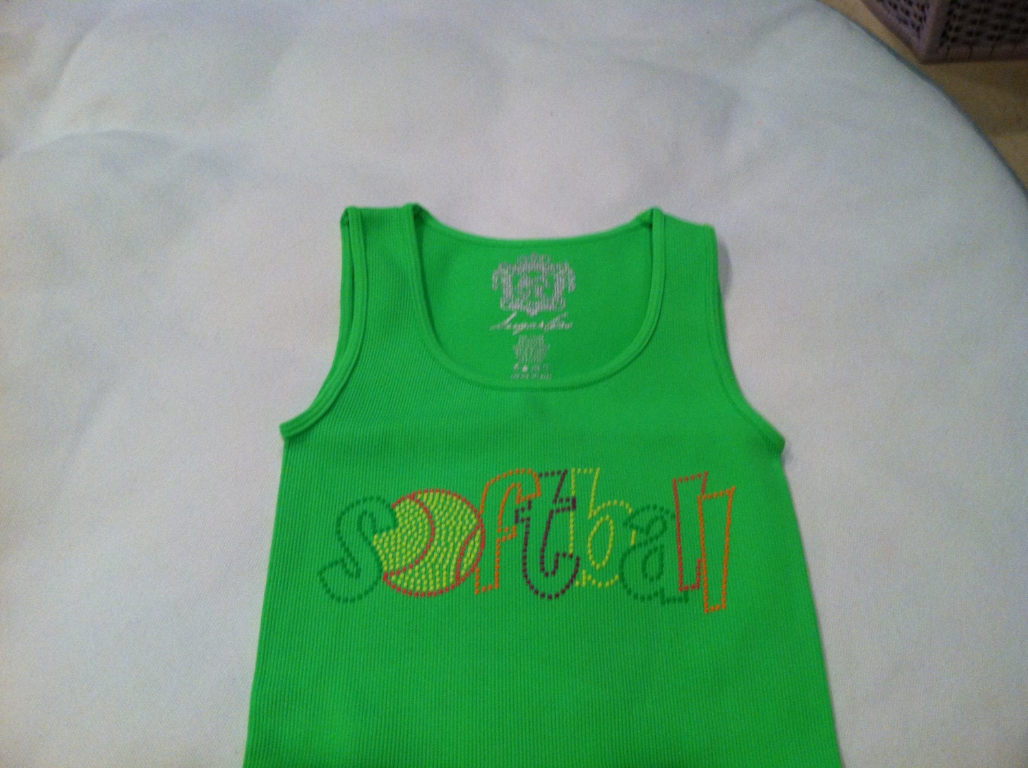 Neon green tank with neon colored nailheads in cheer, dance or softball.