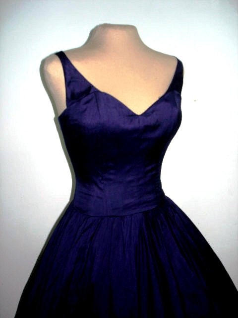 A sexy yet elegant 50s style cocktail dress in gorgeous deep blue satin