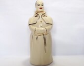 Ceramic priest decanter in a white cassock