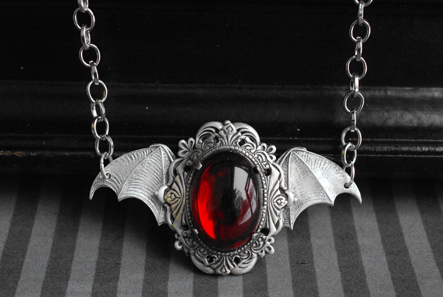 Wings of the Night - antique silver short necklace with bat wings and red glass cabochon