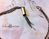 victoria. a feather & bullet brass necklace.
