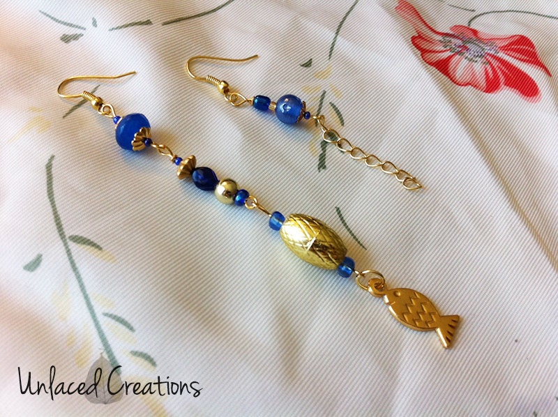 kolyena. a pair of blue & gold asymmetrical beaded earrings (with fish charm)