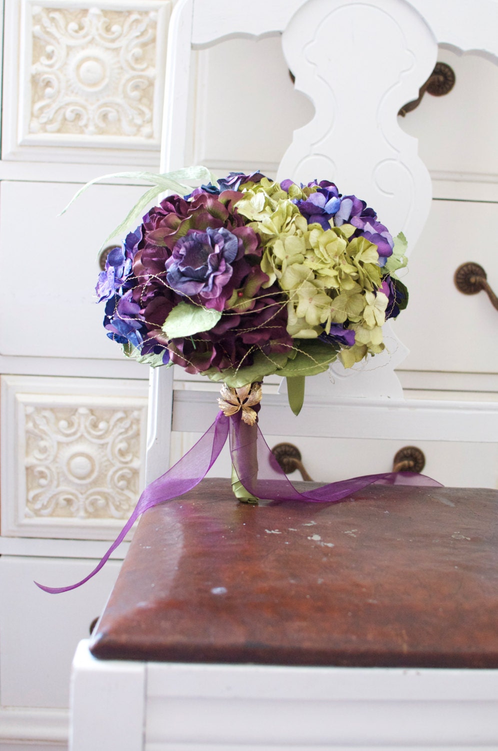 Vineyard harvest bouquet of deep plum, purple wine, vintage green and seasoned purple paper hydrangea accented with gold