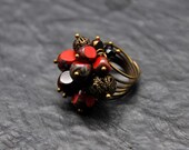 Beautiful dangle ring made with Red and black faceted czech Picasso crystal beads and antiqued brass filigree beads