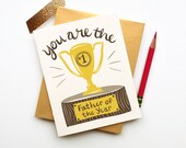 You Are the Father of the Year dads day card calligraphy handwriting gold brown wood congrats new baby award trophy clever funny handsome