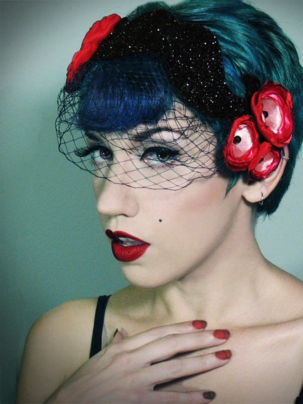 mustache shaped cocktail hat with veil and flowers