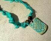 Mariee. Lace Textured Polymer Clay Pendant on Recycled Sari Silk Ribbon. Turquoise, Seafoam, Pale Blue. Chocolate Brown Wooden Beads. OOAK.