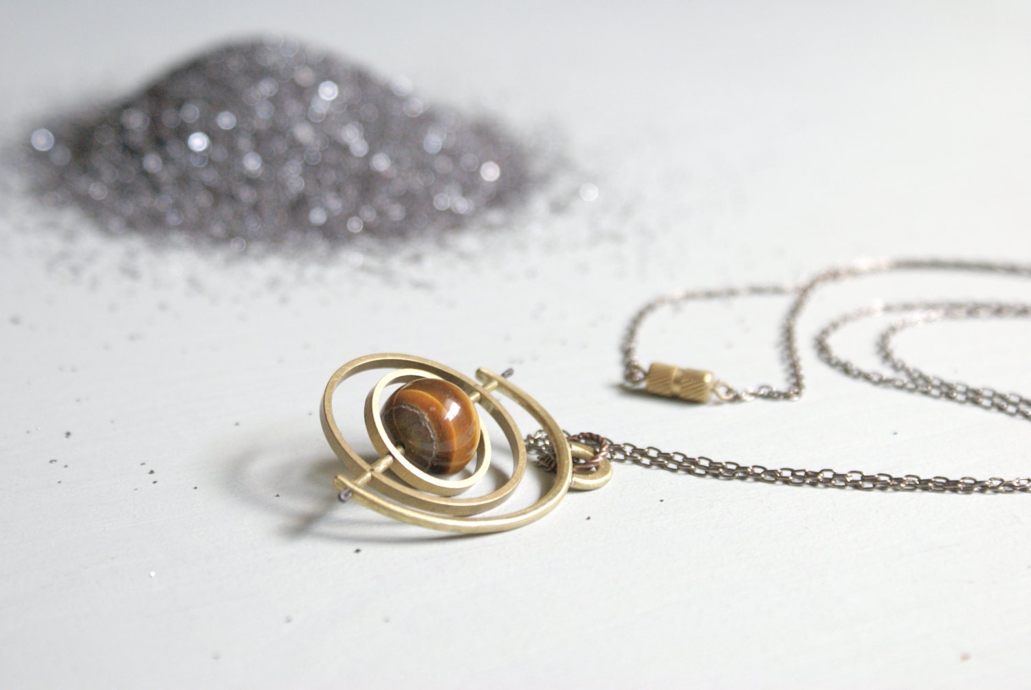 the Saturn Gryoscope necklace - tigers eye sphere