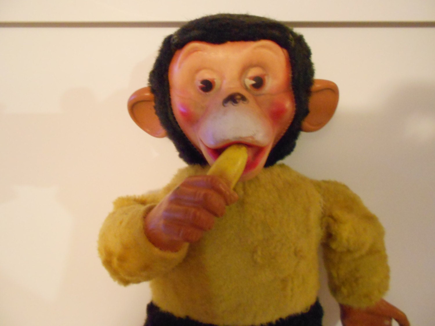 stuffed yellow and black monkey with banana