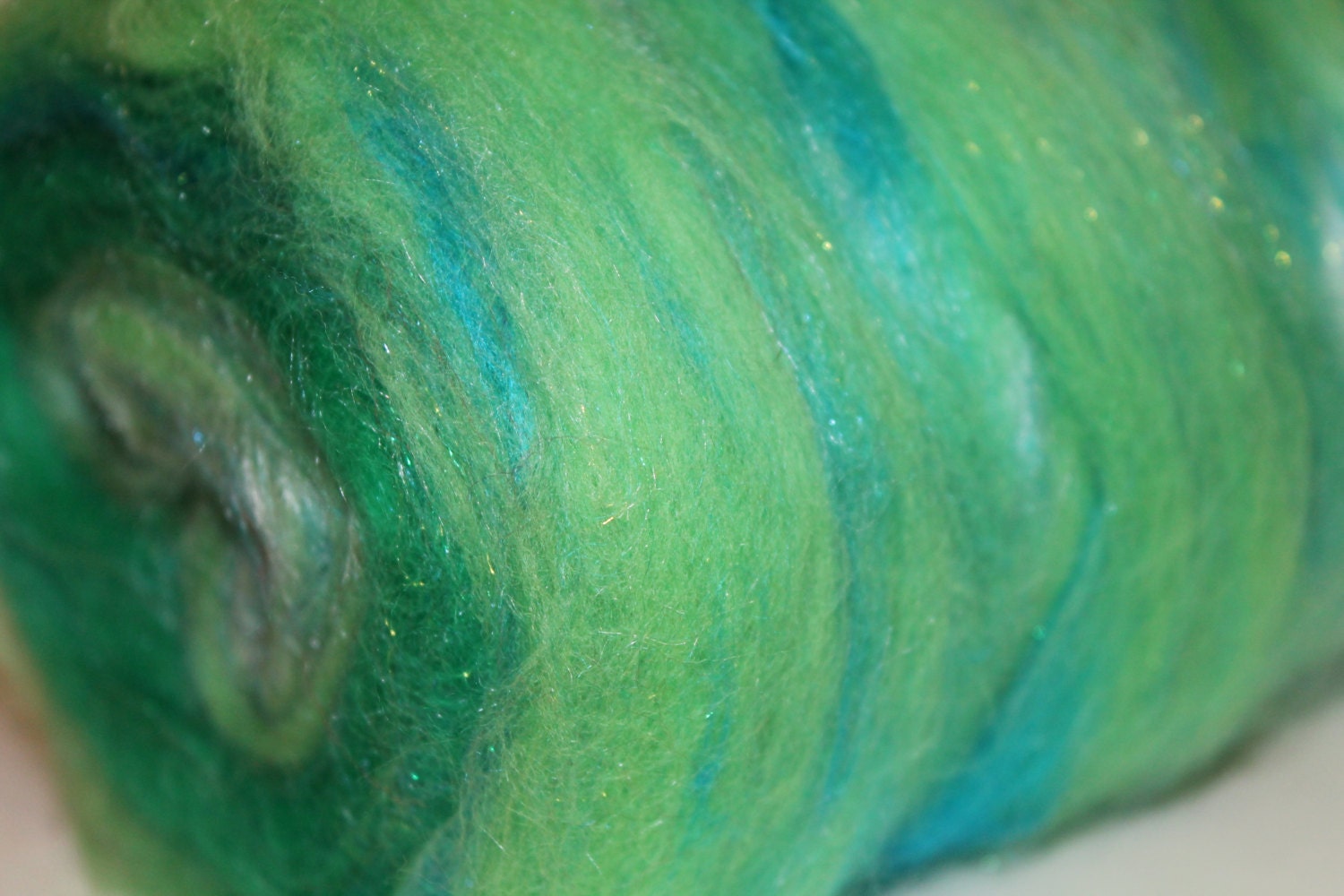 Merino, bamboo, silk, and sparkle center pull roving.  Algae. 3.8oz