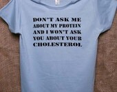 Vegan 100% organic cotton stenciled women's t-shirt in blue - Don't Ask Me About My Protein And I Won't Ask You About Your Cholesterol - VeganeseTees