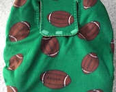 Reversible Baby Car Seat Cover is green with a football print on one side and solid gold on other side. - CreationsForKids