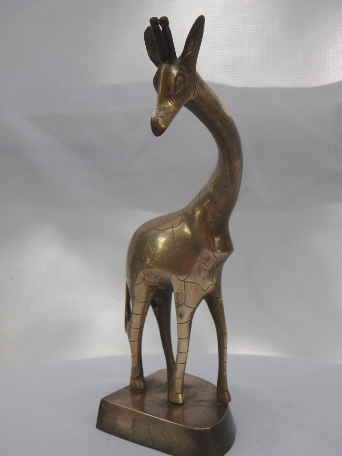 large brass giraffe statue