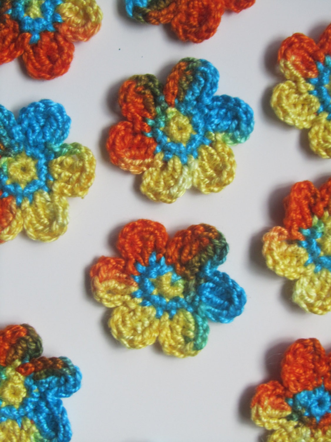 Handmade crocheted cotton flower appliques set of ten orange blue and yellow - PomPomBlue