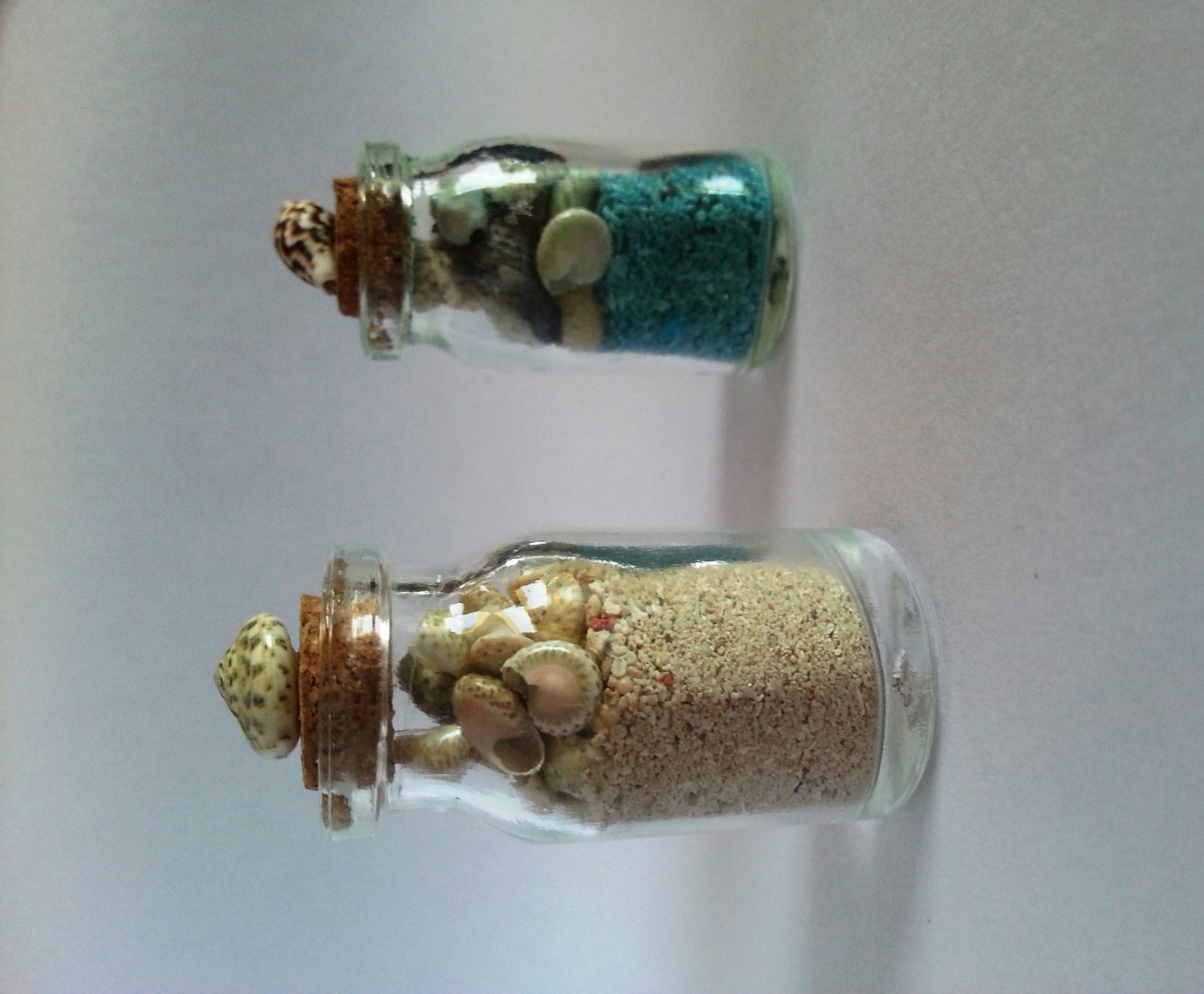 Miniature glass jars with sand & sea shells blue by