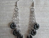 Lightweight earrings featuring aluminum donuts and steel chain.