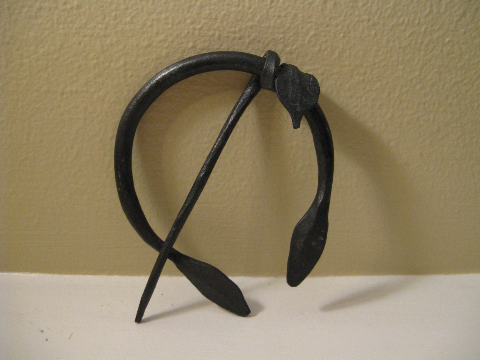 Forged brooch
